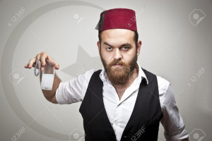 33485885-Man-in-traditional-turkish-hat-and-dress-kabadayi-with-alcohol-raki-Stock-Photo